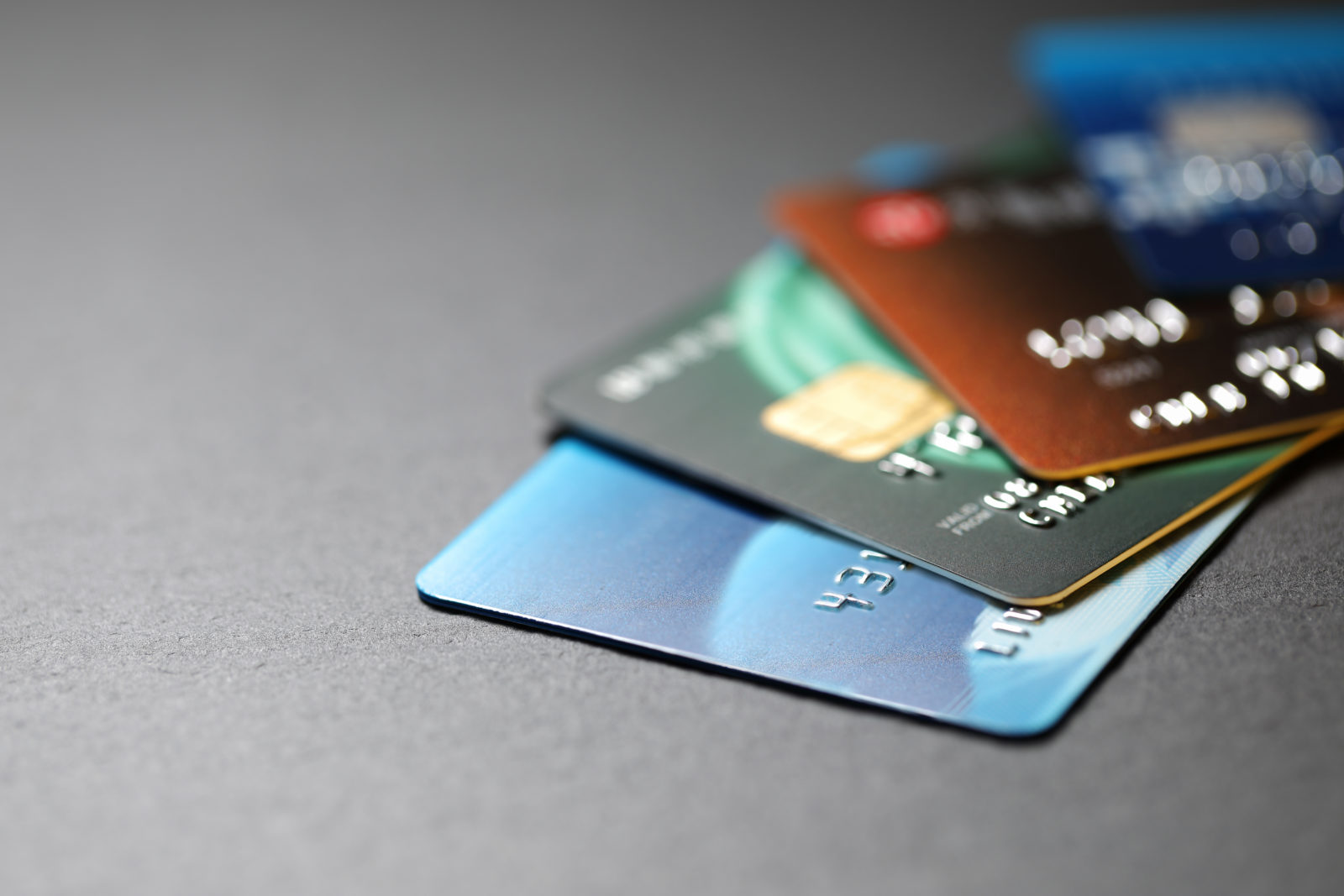 A group of 3DS credit cards on a gray surface.